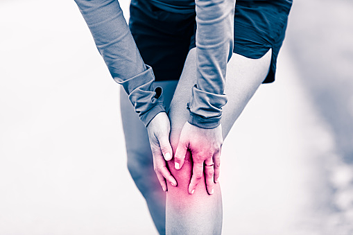 Knee pain, woman holding sore and painful leg
